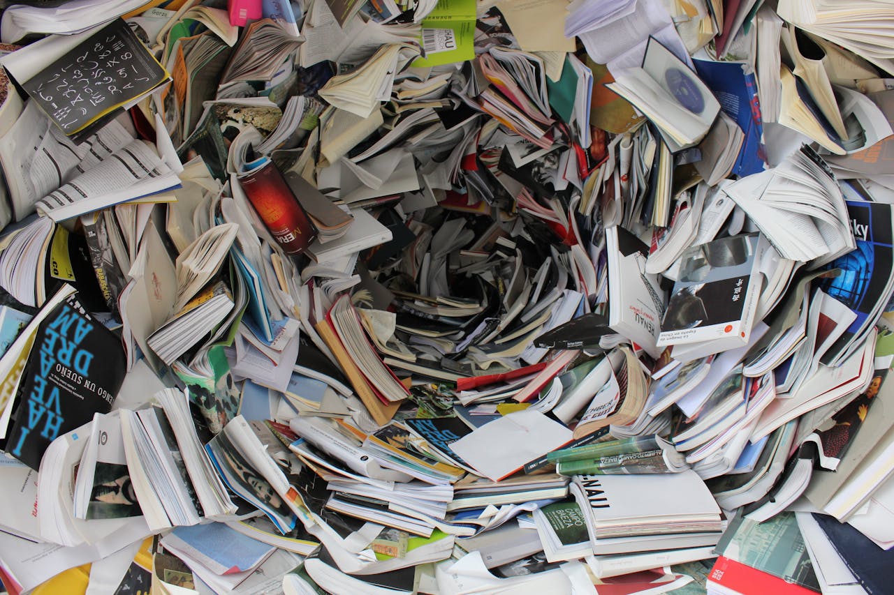 who-we-are A whirlwind of books and papers creating a chaotic visual. Ideal for concepts of disorder or information overload.